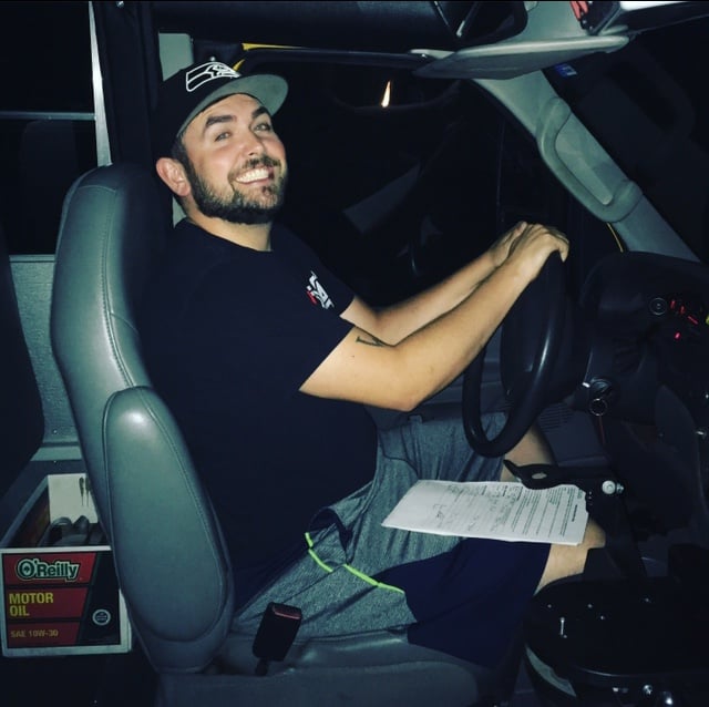 Aaron sits in the driver’s seat of the bus.